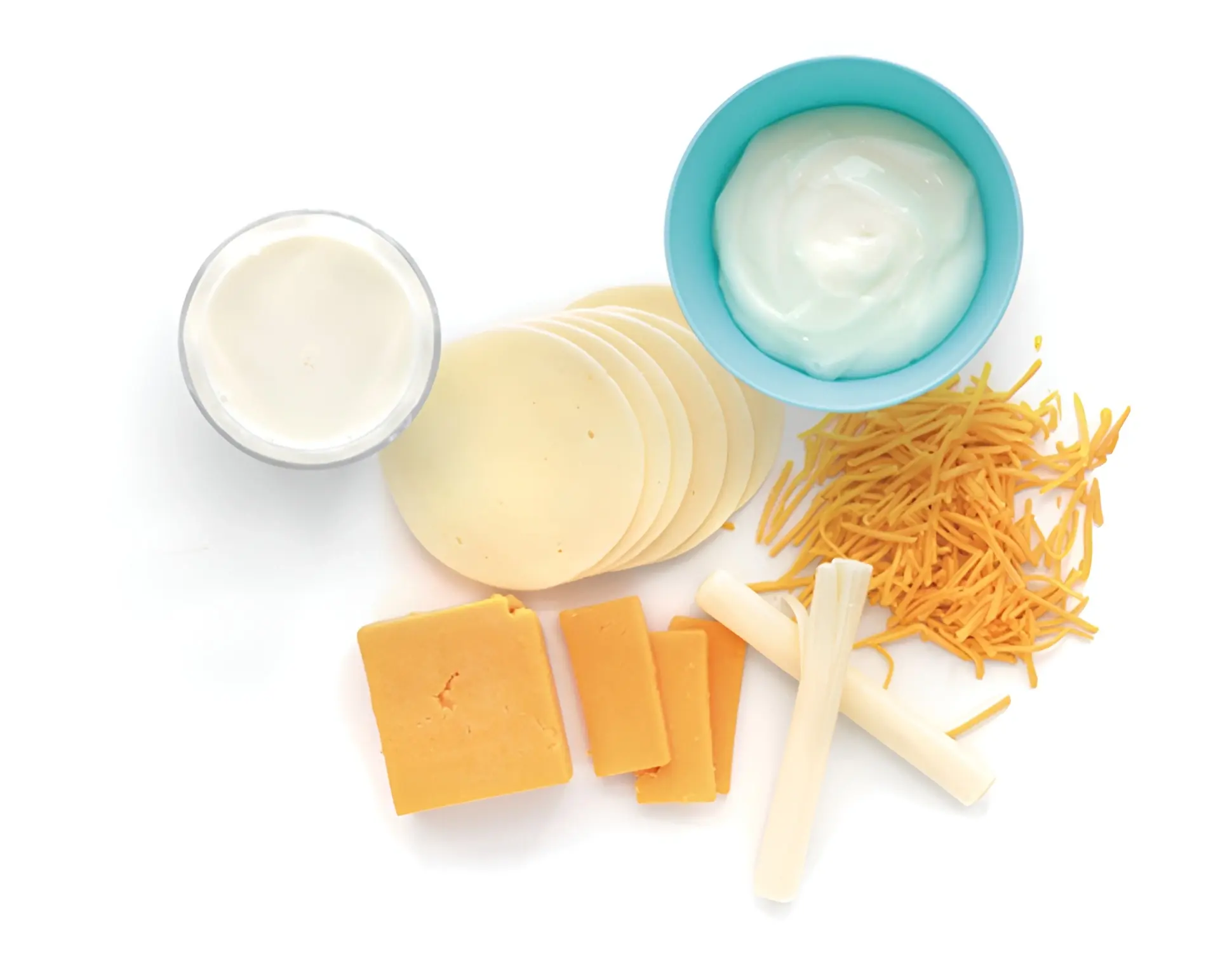 Assortment of dairy products, representing one cup of milk, yogurt, and portions of cheese.