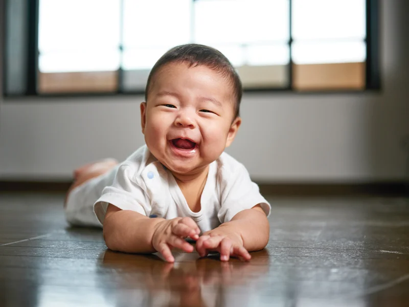 Baby Smiling On Floor