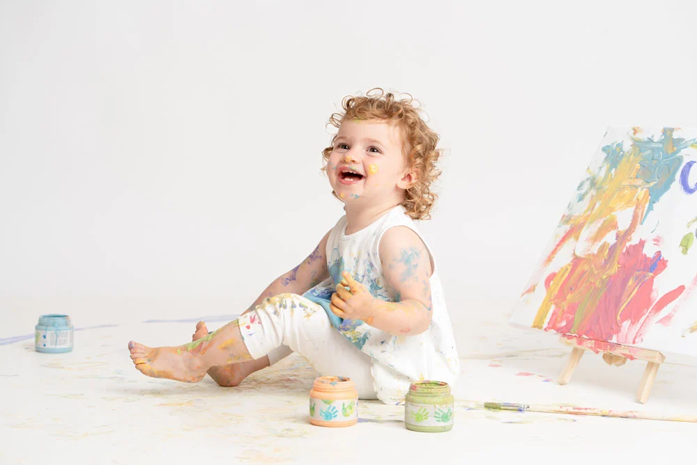 Toddler playing with finger paint