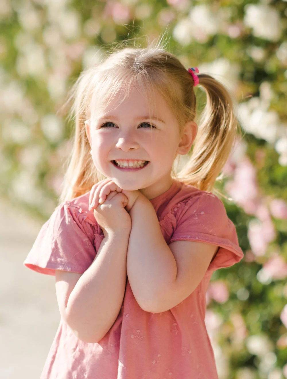 Smiling girl outdoors with flowers
