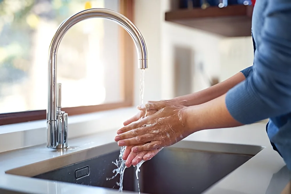 washing hands under tap