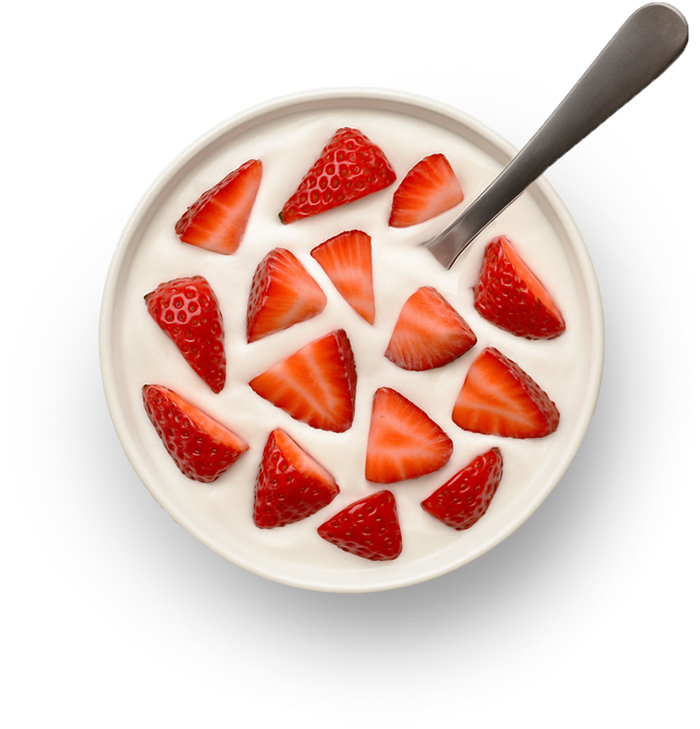 Yogurt topped with fresh strawberry slices and spoon.