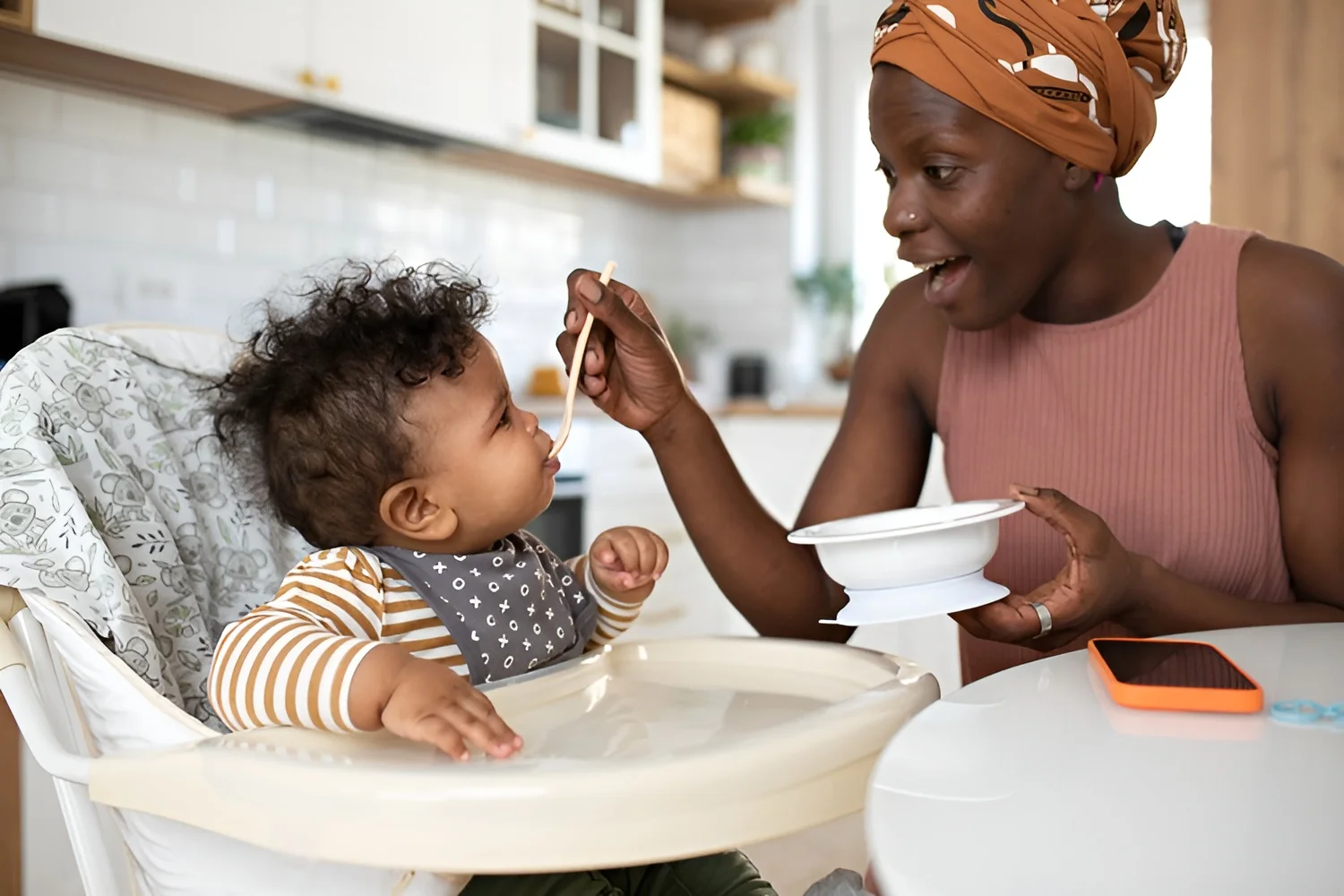 mom with spoon feeding baby