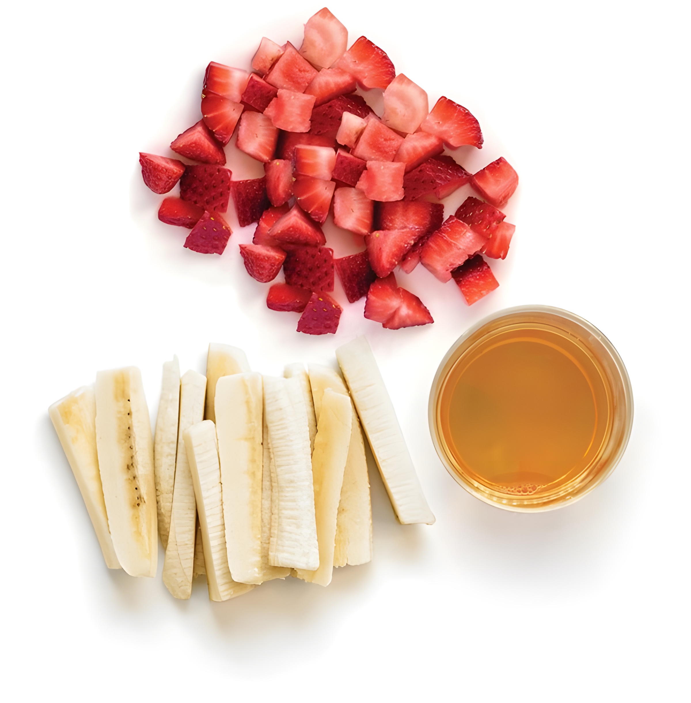 Chopped strawberries, sliced bananas, and apple juice glass
