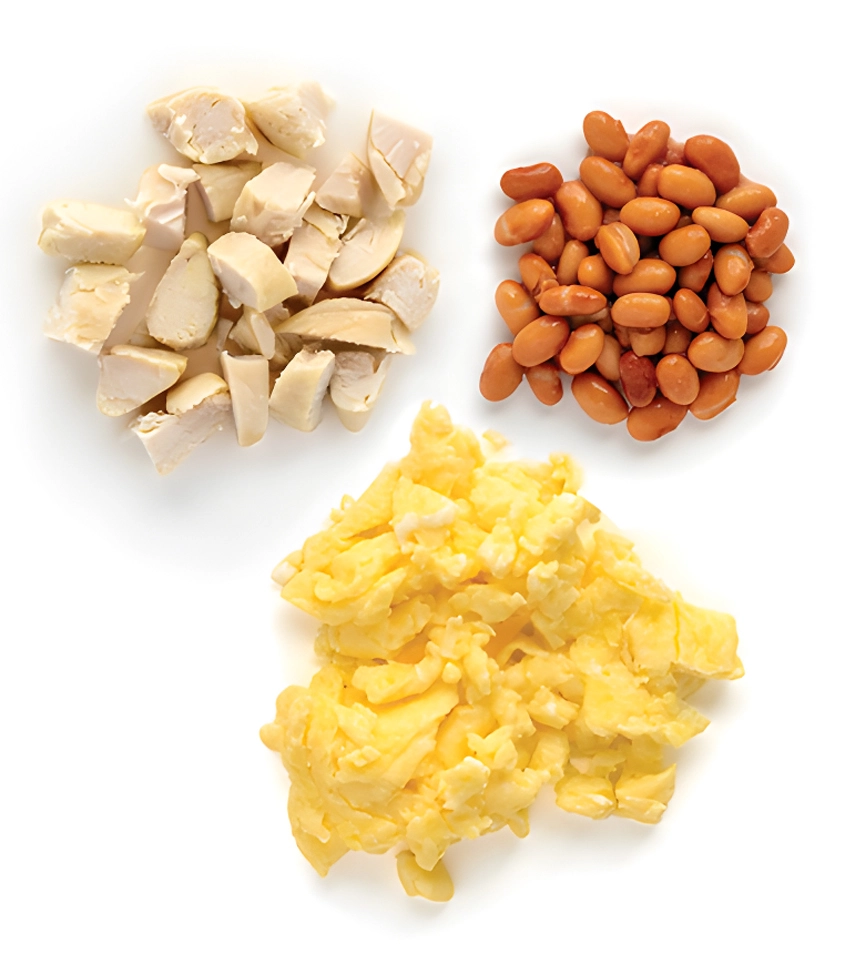 Chicken, beans, and scrambled eggs on white background