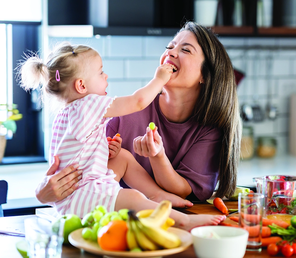 Mother and daughter eating healthy food together